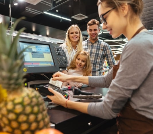 smiling-family-paying-with-credit-card-min